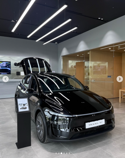 안성 스토어에 전시된 검은색 Model Y, 프렁크가 열린 모습과 MODEL Y 명패 사양 안내 스탠드